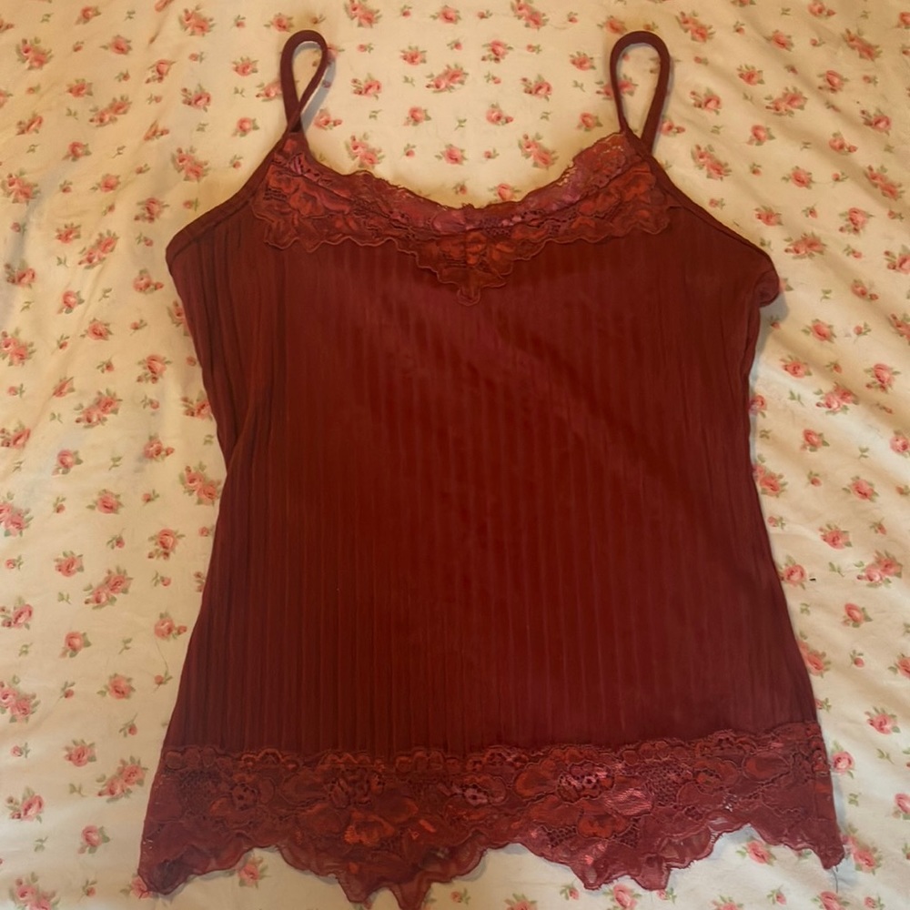 Red tank top with floral lace at top and bottom has not been worn often
